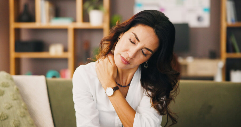 Woman experiencing neck muscle soreness after a car accident, illustrating common soft tissue pain following a collision.