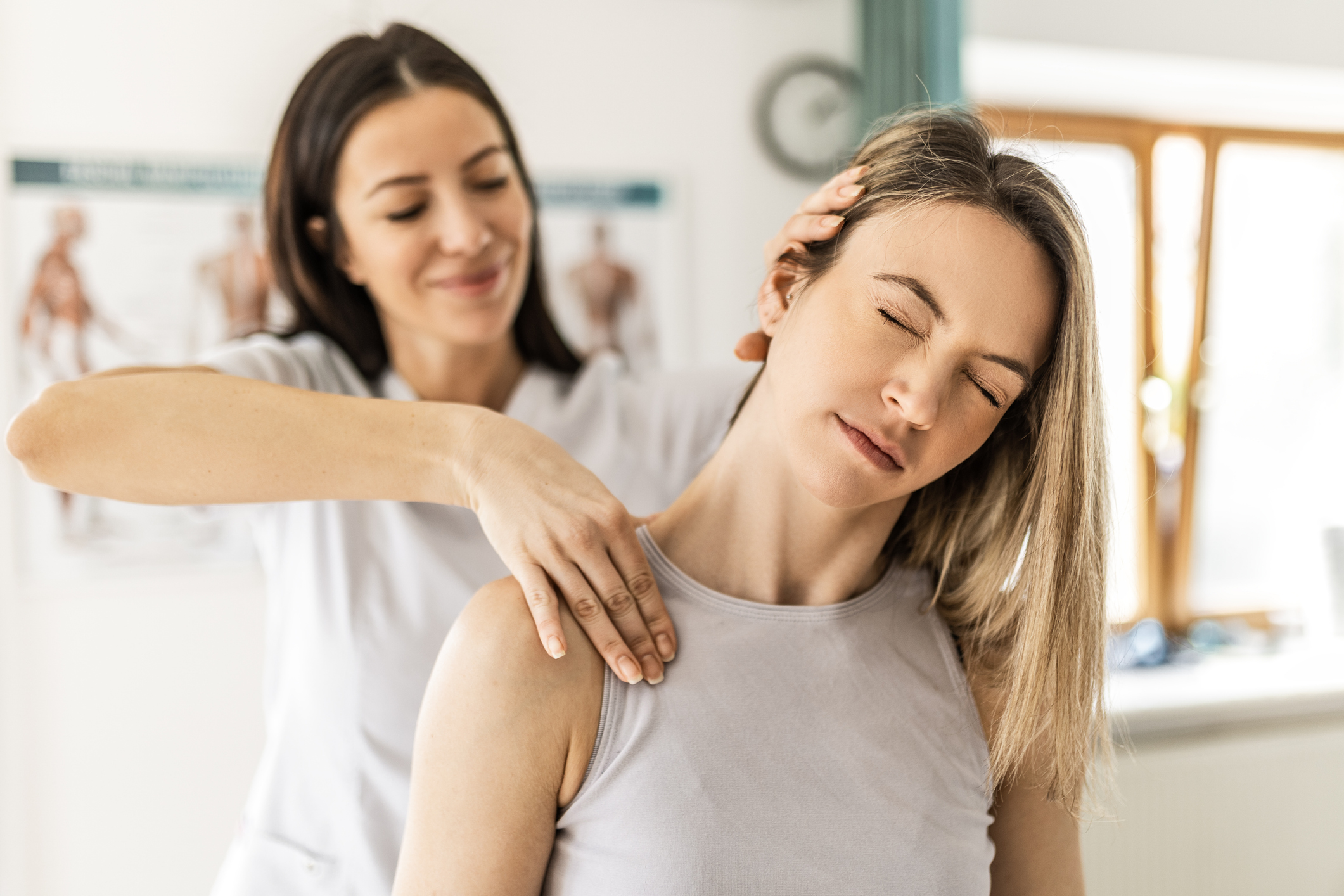 Chiropractor providing gentle neck adjustment for a patient during personalized auto accident treatment in Naples, Florida