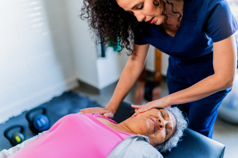 Chiropractor providing evidence-based soft tissue and spinal care to a patient during a treatment session in Sarasota, Florida
