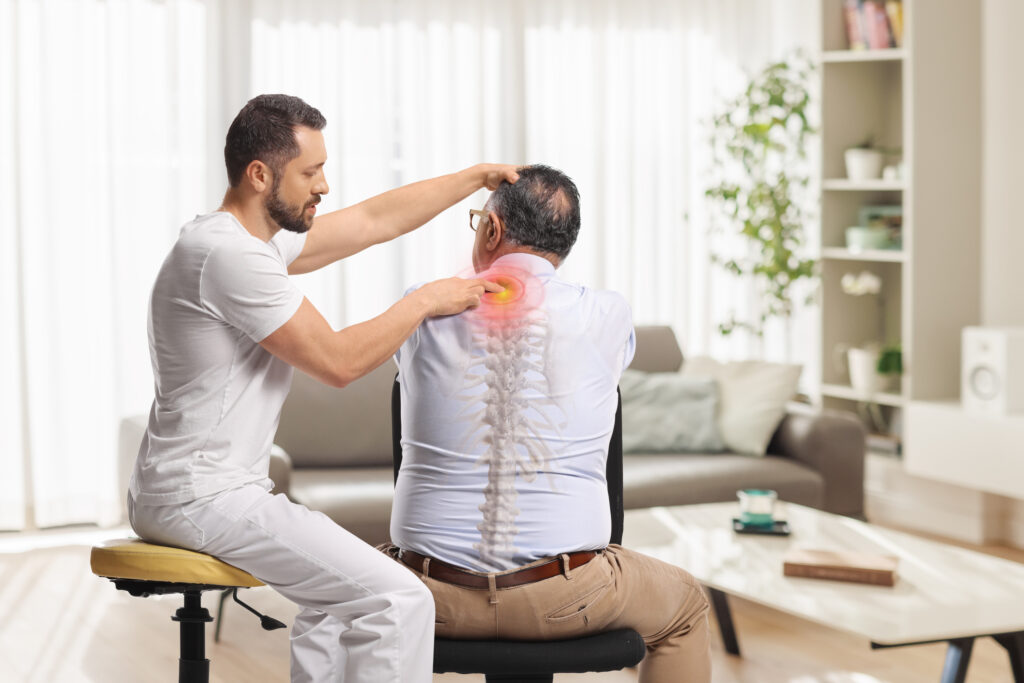 Chiropractor assessing neck and upper back pain in a patient during personal injury treatment after a car accident in Tampa