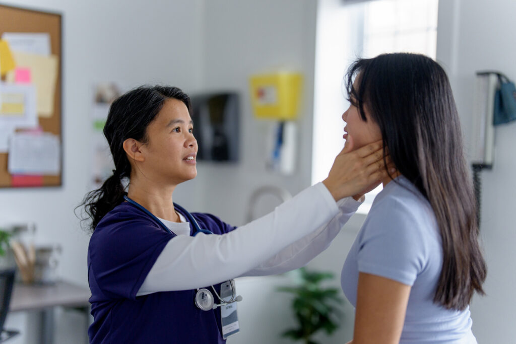 Healthcare provider evaluating a patient with neck pain after a car accident before discussing radiofrequency ablation treatment options.