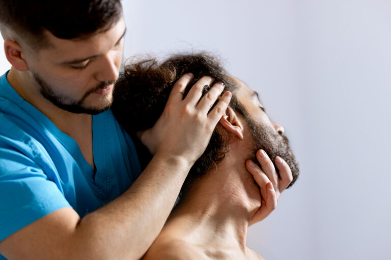 Healthcare provider performing a neck assessment on a patient experiencing neck pain after a car accident.