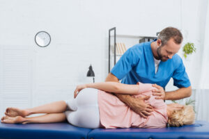 Chiropractor evaluating a patient after a car accident at a Fort Myers, Florida injury clinic.