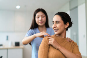 Healthcare provider evaluating a patient after a car accident at an injury clinic in Naples, Florida.